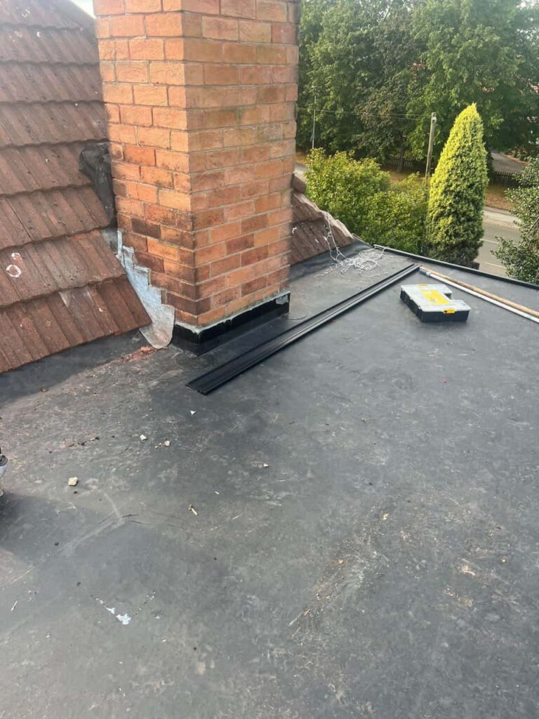 This is a photo of a flat roof which has just been repaired, there is also a chimney stack and some leadwork has also been dressed. Works carried out by LJ Roofing Haydon Wick