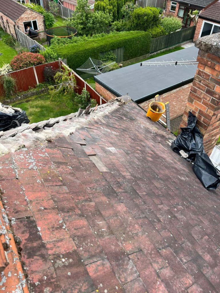 This is a photo of a roof where the hip tiles have been removed, and are just about to be replaced. Works carried out by LJ Roofing Haydon Wick